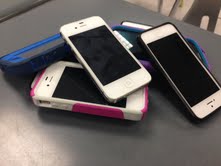 cell phones pile up as they head to lockers before the 9am bell.