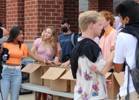 Handing out t-shirts on the first day of school, SCA President Simren John hopes the return to school brings a renewed sense of school spirit.
