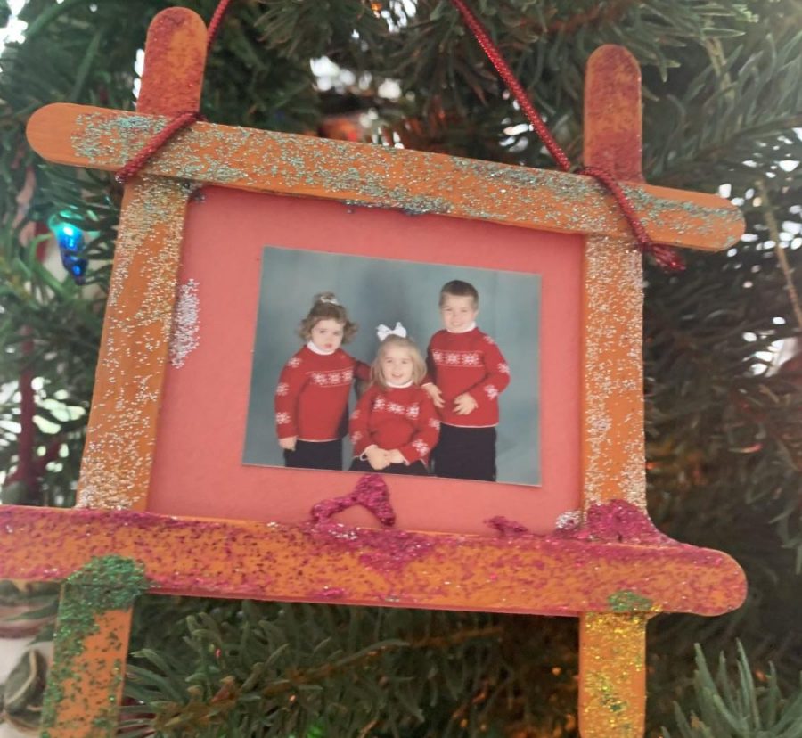 The picture of Caelan, Anna and Aidan is covered in glitter, clearly made by one of the kids.