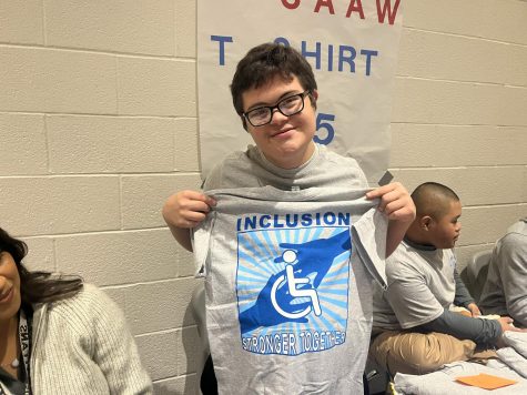 T-shirts are available during lunch shifts with Isaac Medrano holding one up.