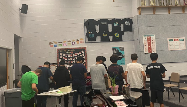 Students praying together in the choir room during 7th block.