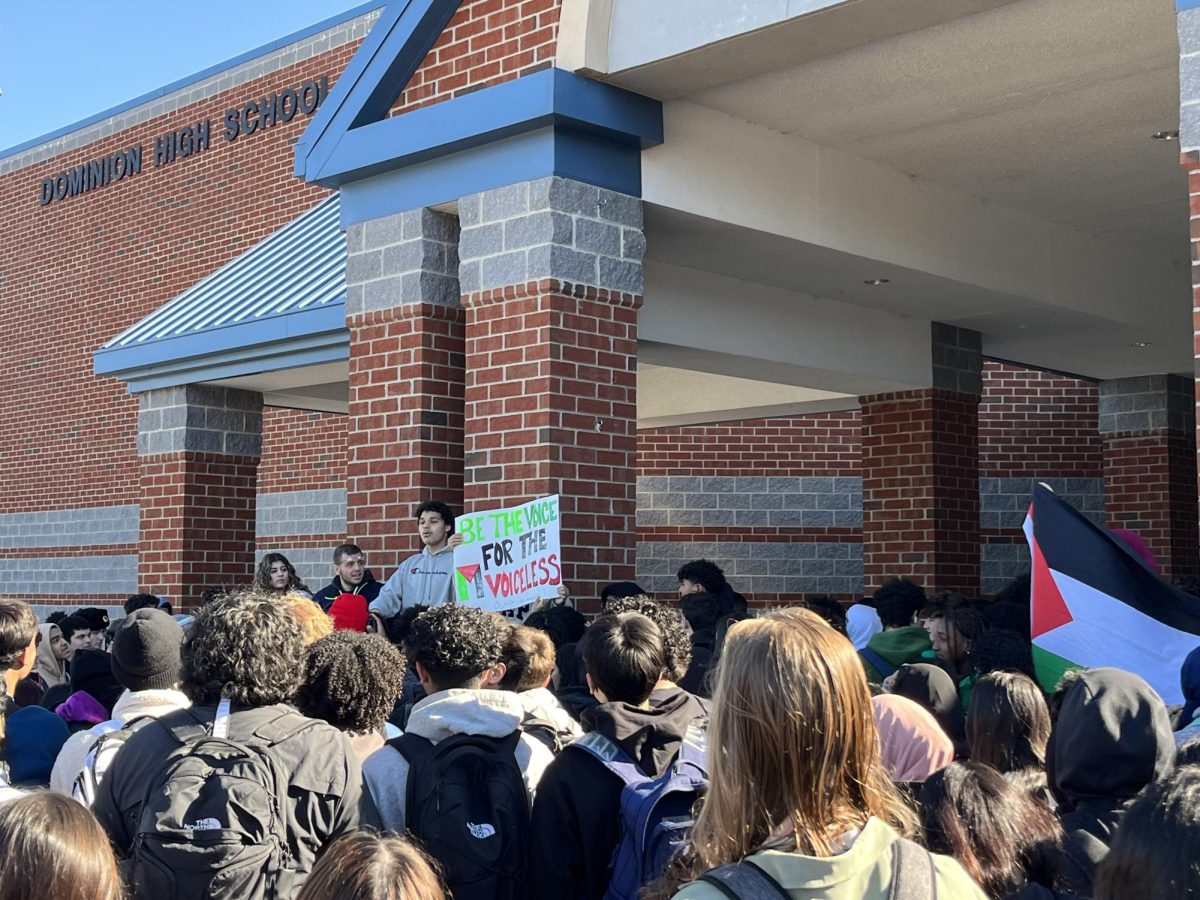 Students+displayed+signs+and+a+Palestinian+flag+during+the+walkout