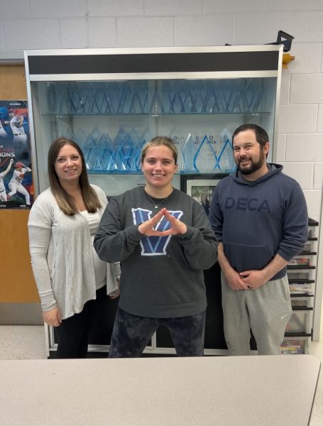 With a DECA Diamond in tow, Callie is pictured with her favorite Marketing Duo, in front of Dominion DECA glass.