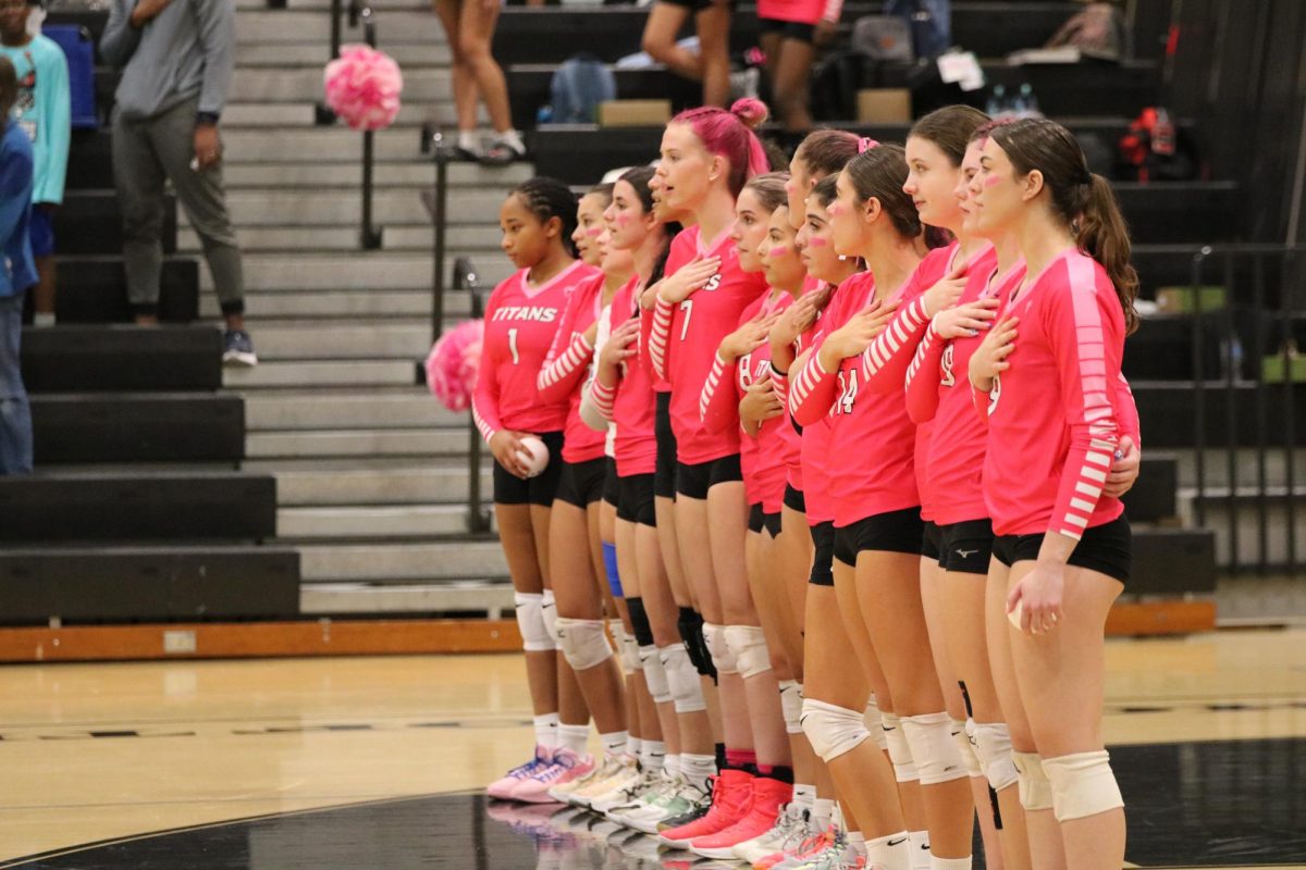 Before their Pink Out for Breast Cancer Awareness, Titan Volleyball stood together for the Pledge of Allegiance. 
