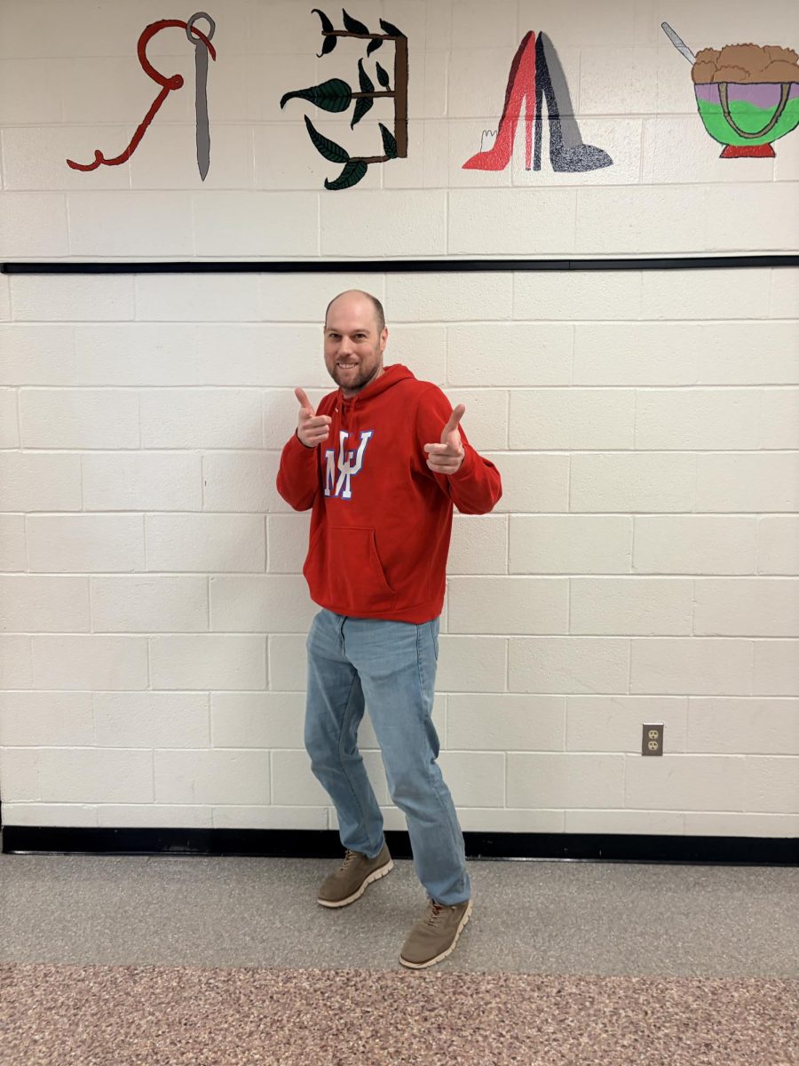 Mr Demott posing for a picture in the science hallway.