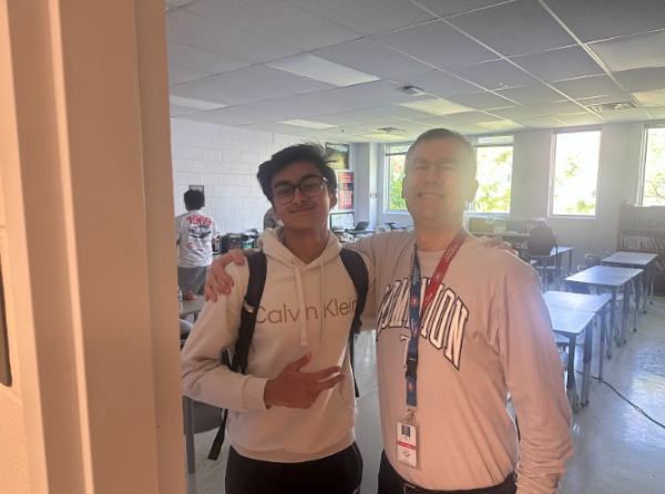 Zayd and Mr Banks posing together with big smiles. 